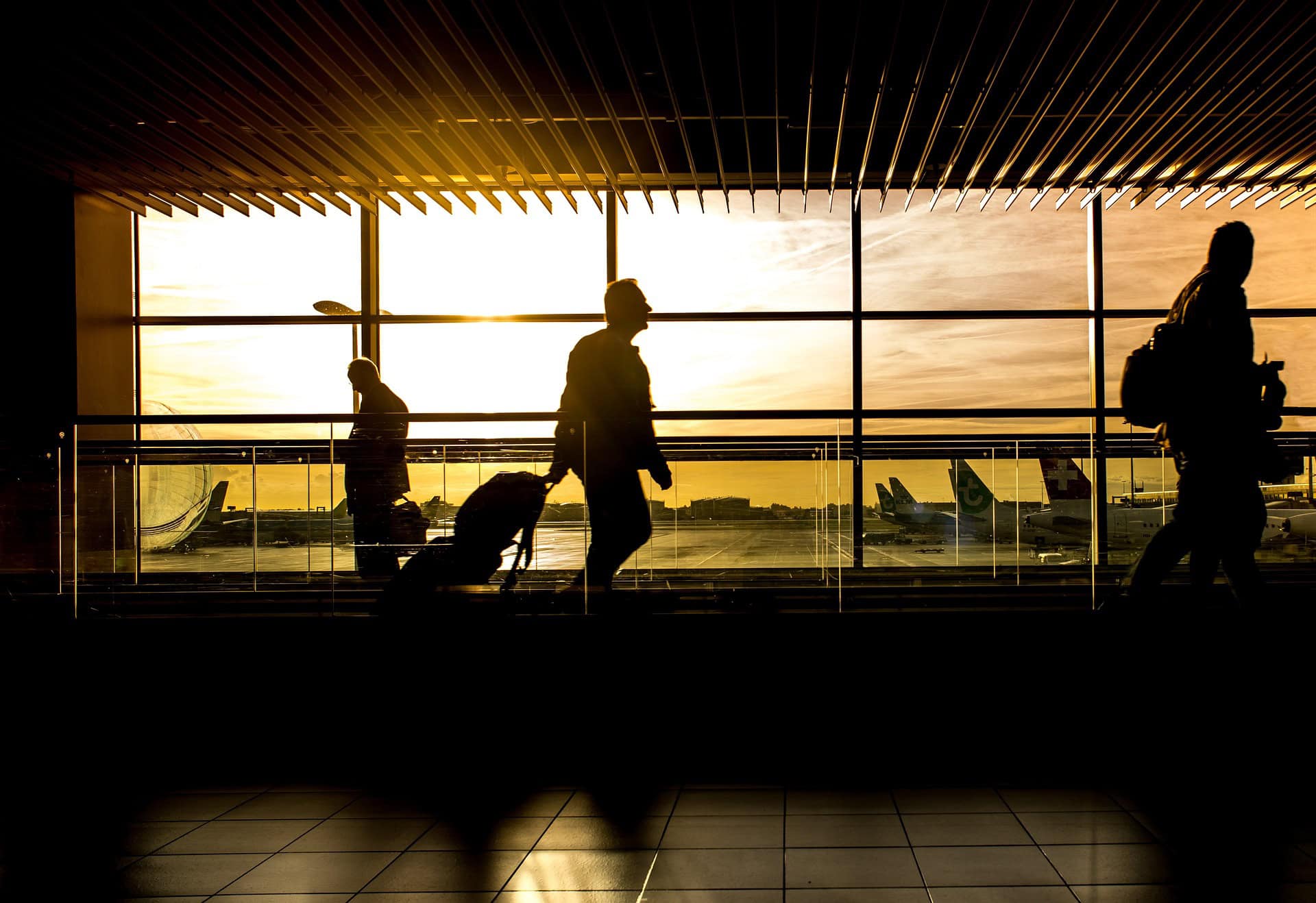image of people walking through an airport