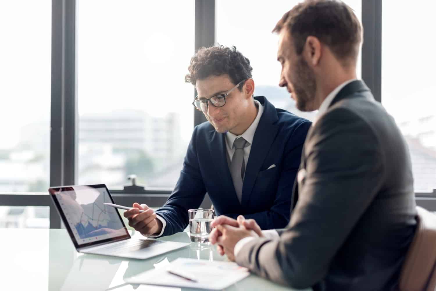 image of two men working on a laptop