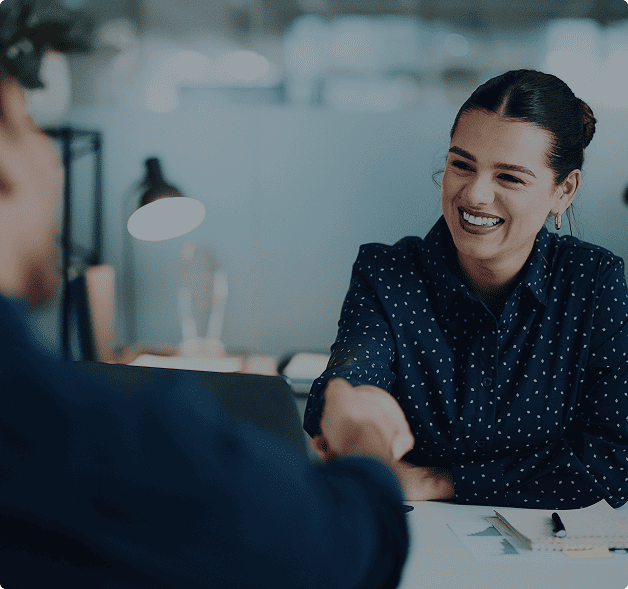 image of a woman greeting someone at a desk