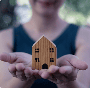 image of a child holding a toy house
