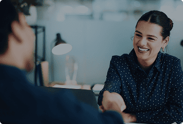 image of a woman greeting someone at a desk